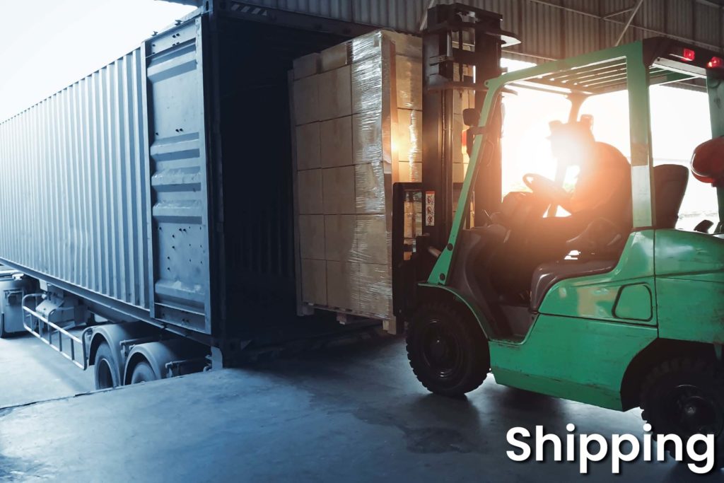 Forklift loading shipment goods pallet into container shipping truck. Cargo freight, Logistics and transportation.