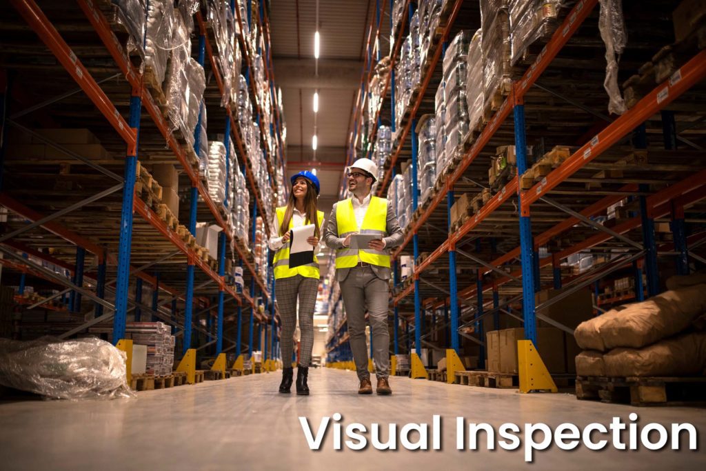 Managers walking through large warehouse controlling and inspecting goods distribution.